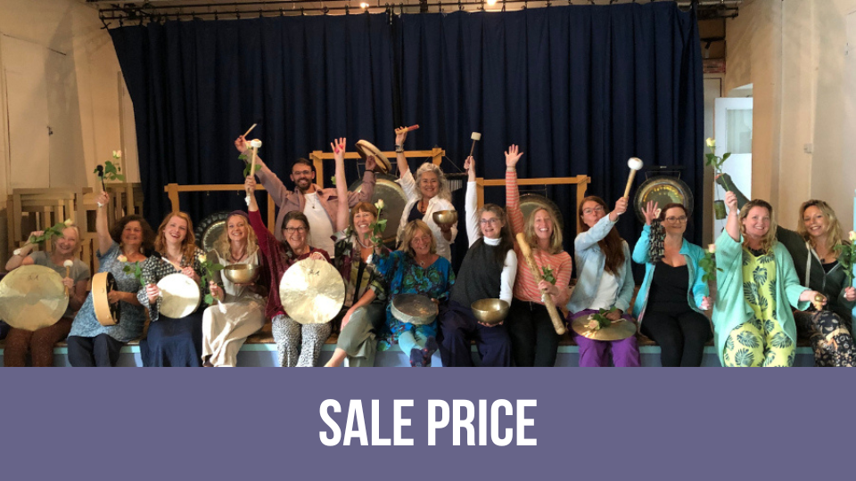 Sound healer holding handheld frame drum