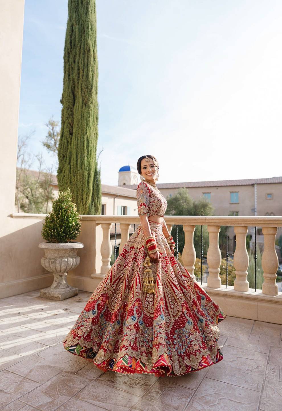 South Asian bride in an embroidered lehenga on a sunlit terrace, filmed by Happy Soul Films