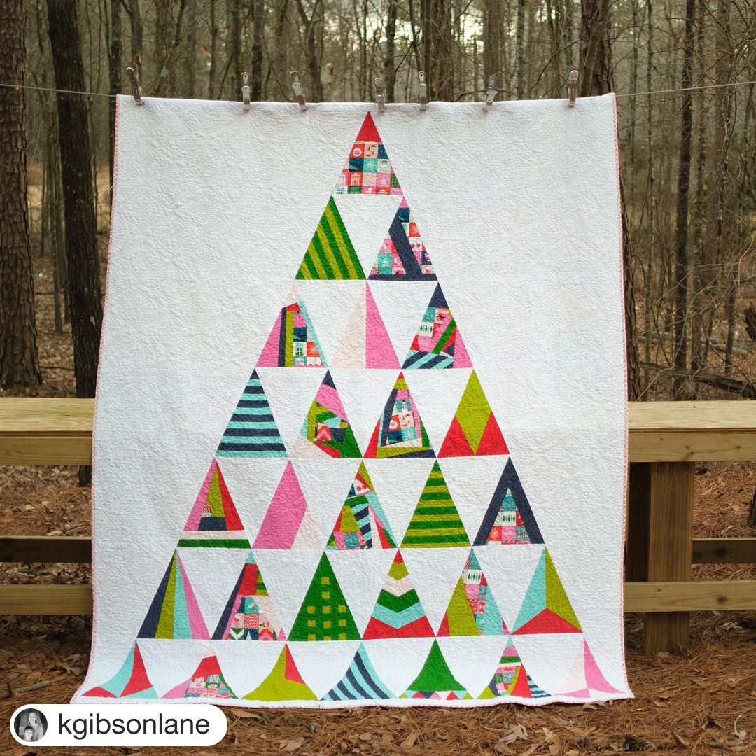 Merry Modern Triangles quilt with triangles arranged in a tree shape.