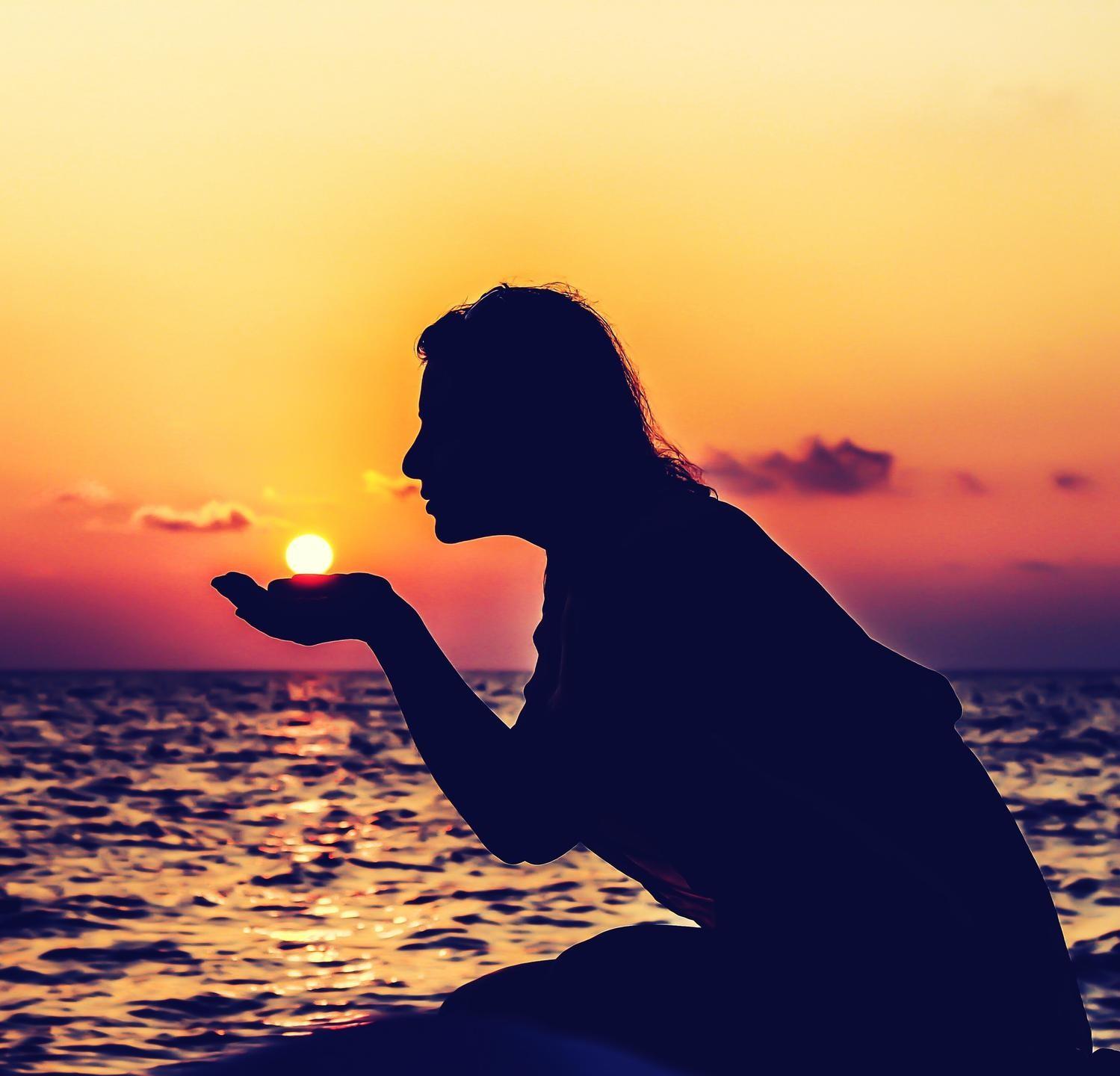 Woman holds the sun