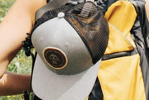 Grey hat on a backpack
