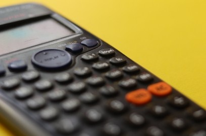 A close up of a calculator on a yellow background