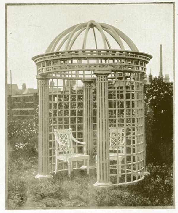 Black and white photograph of elaborate trelliswork structure built to have the walls used to grow climbing roses.