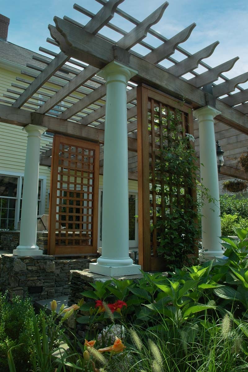 Mahogany diagonal trelliswork set as side walls for portal pergola.