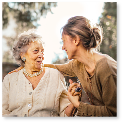 Caregiver holding elderly woman