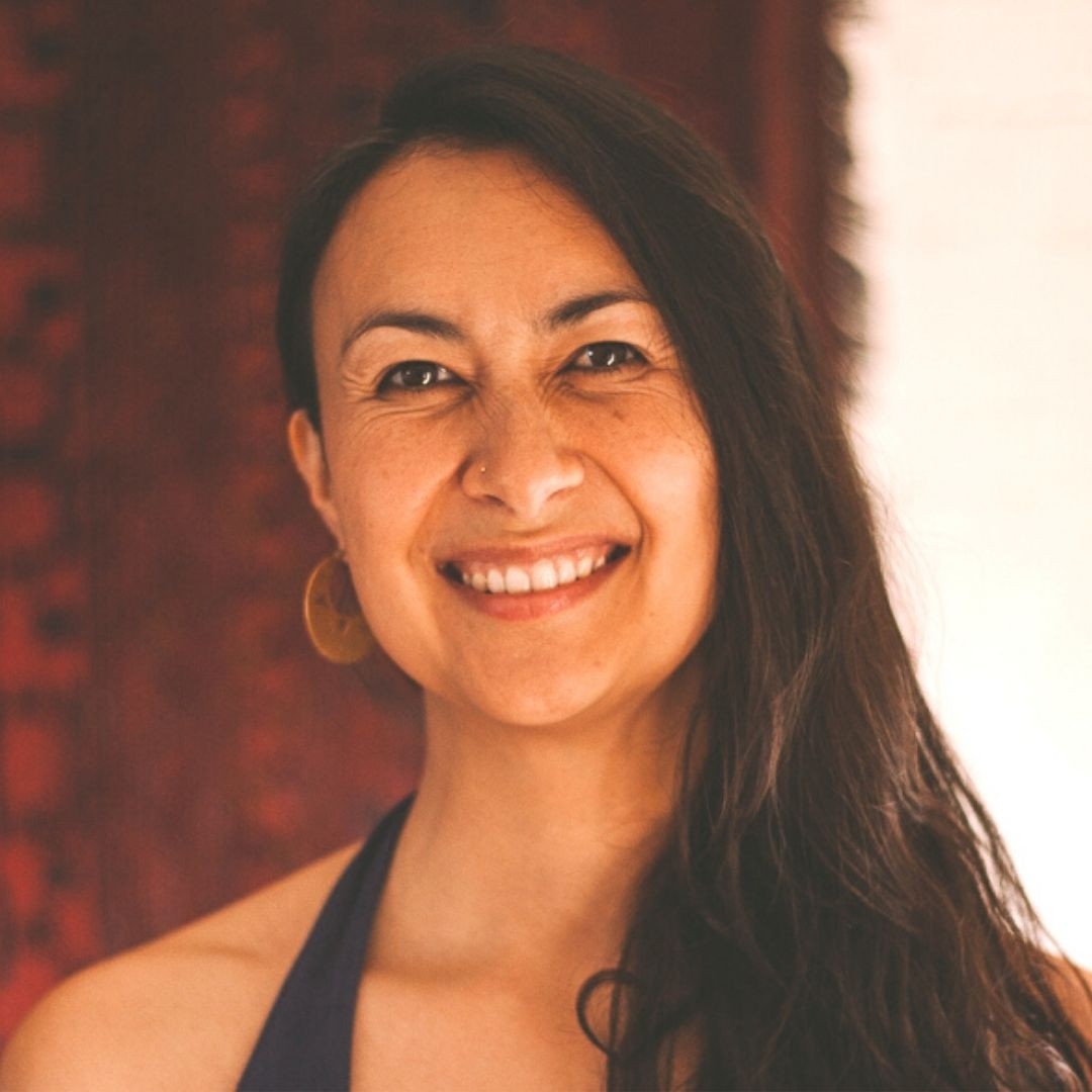 A photo of Mei Lai, a Eurasian woman with long hair, smiling