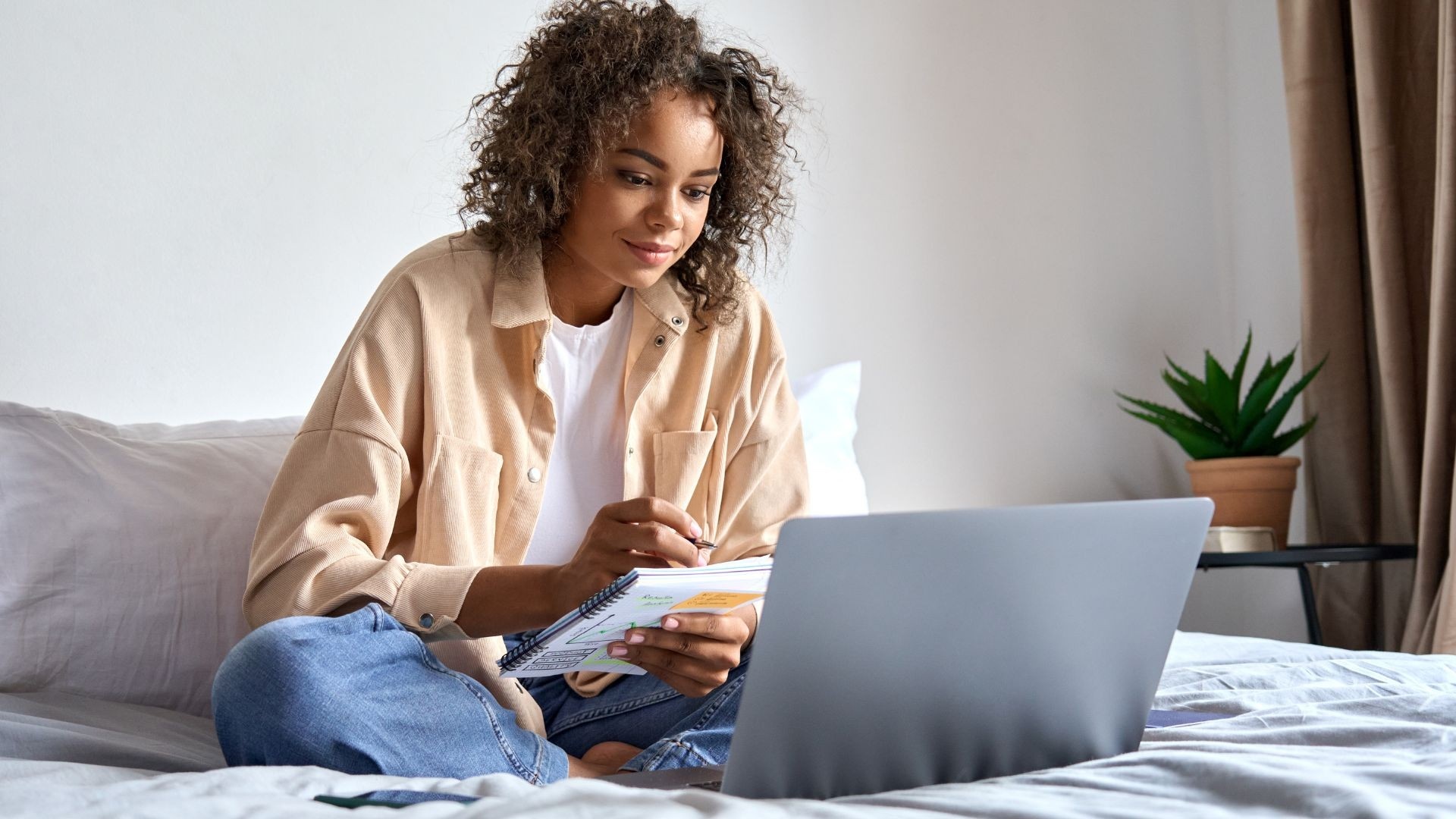Woman Creating a Kajabi course on laptop