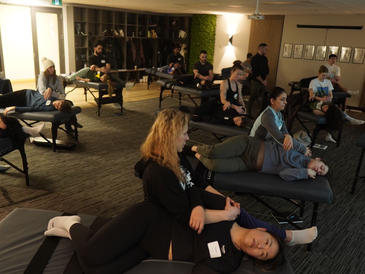 The full room in open practice, every table in use
