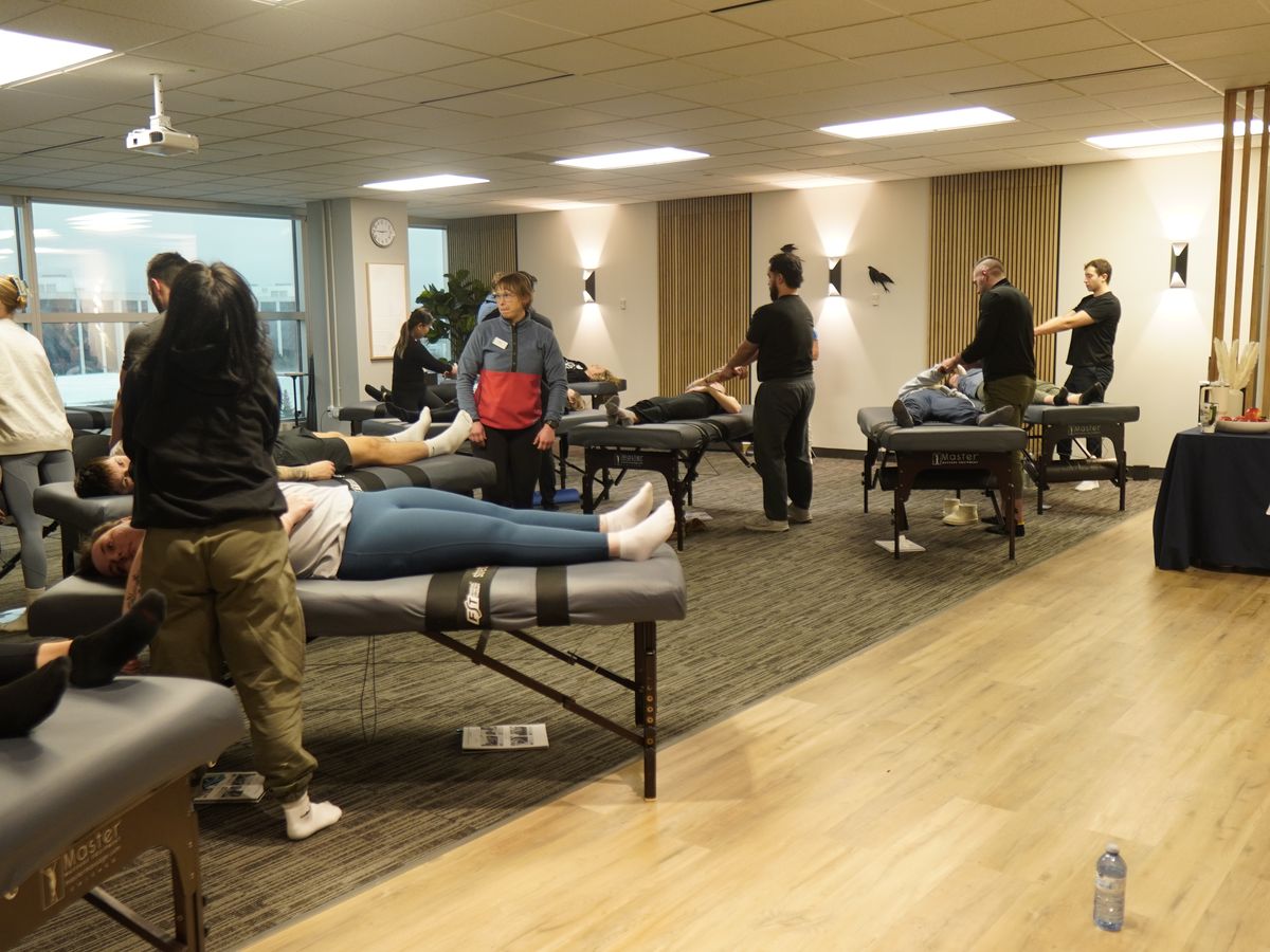 The training room, tables in rows, students working in pairs