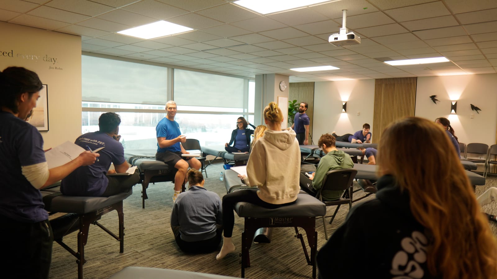 An instructor demonstrating to the seated group