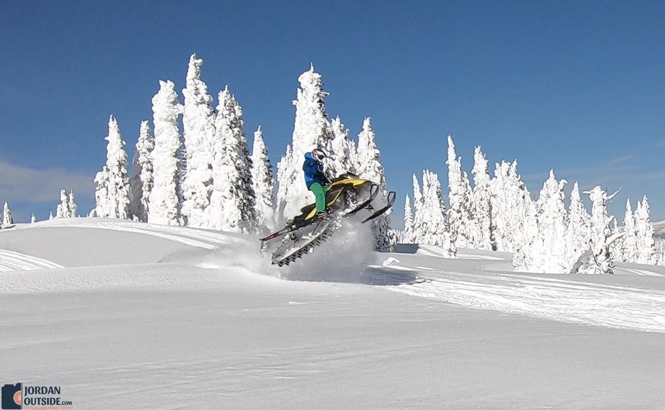 Gary taking a jump on his snowmobile