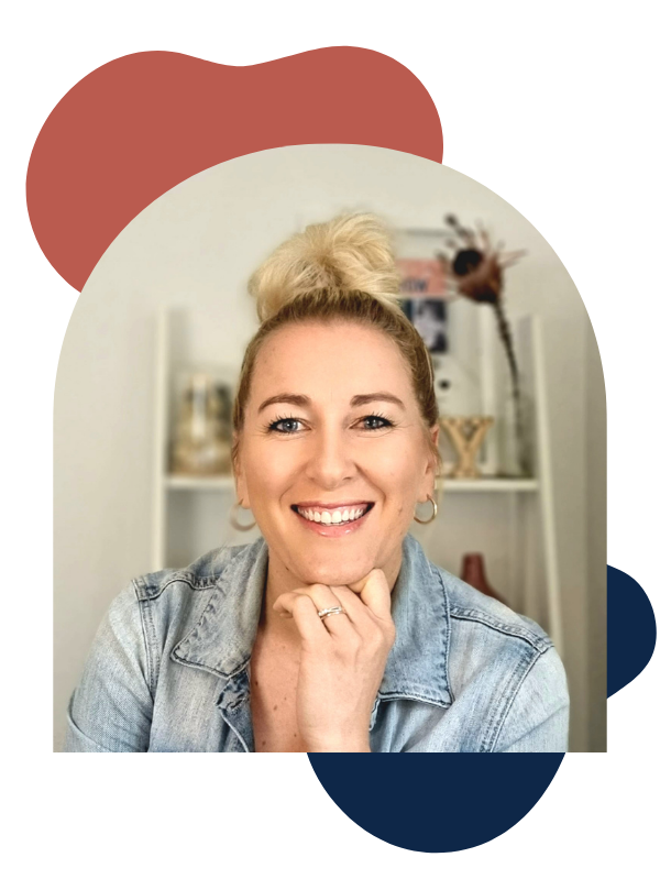 Jo Jensen smiling in front of pink wall