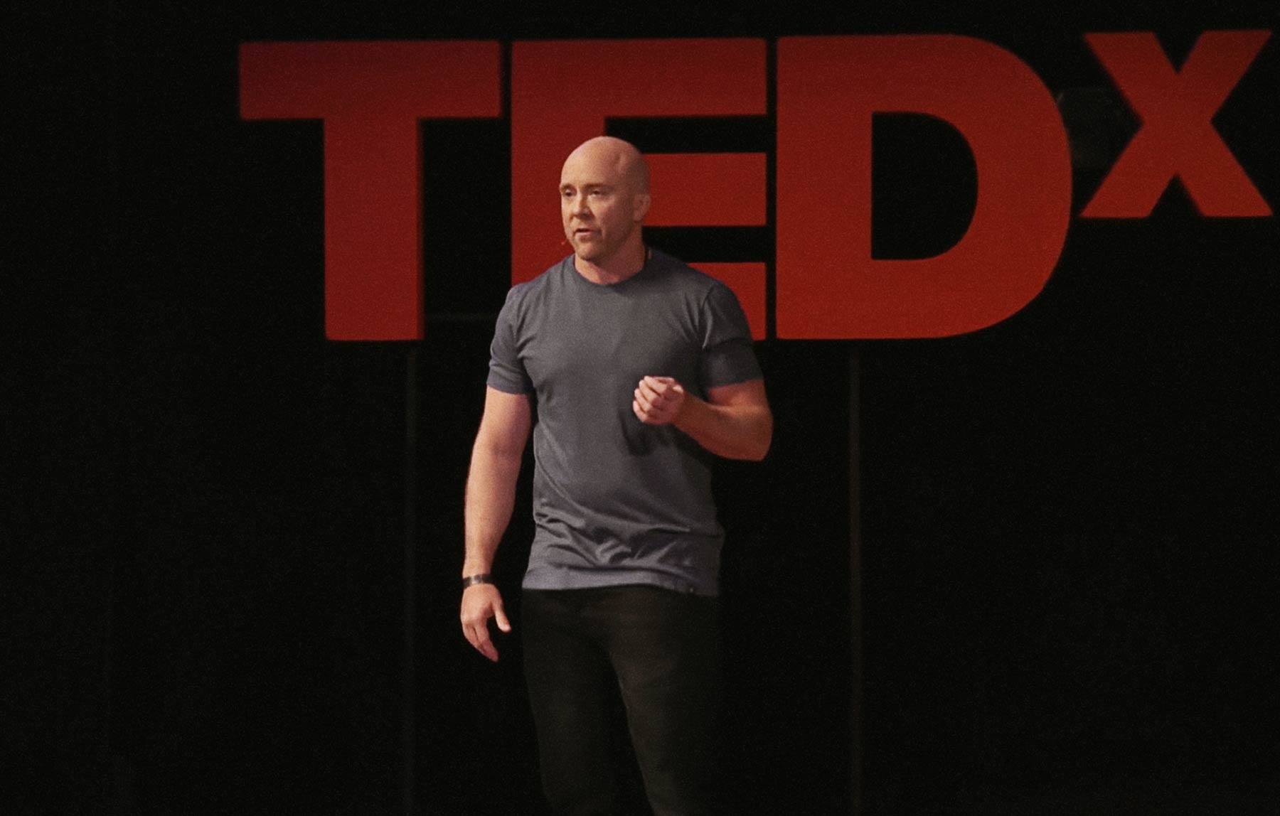 Traver Boehm on-stage giving a TEDx talk