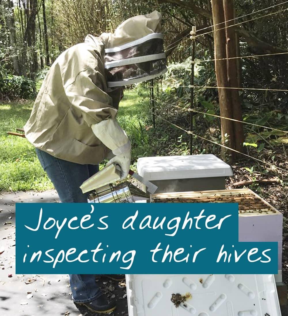 online beekeeping course student inspecting her hive